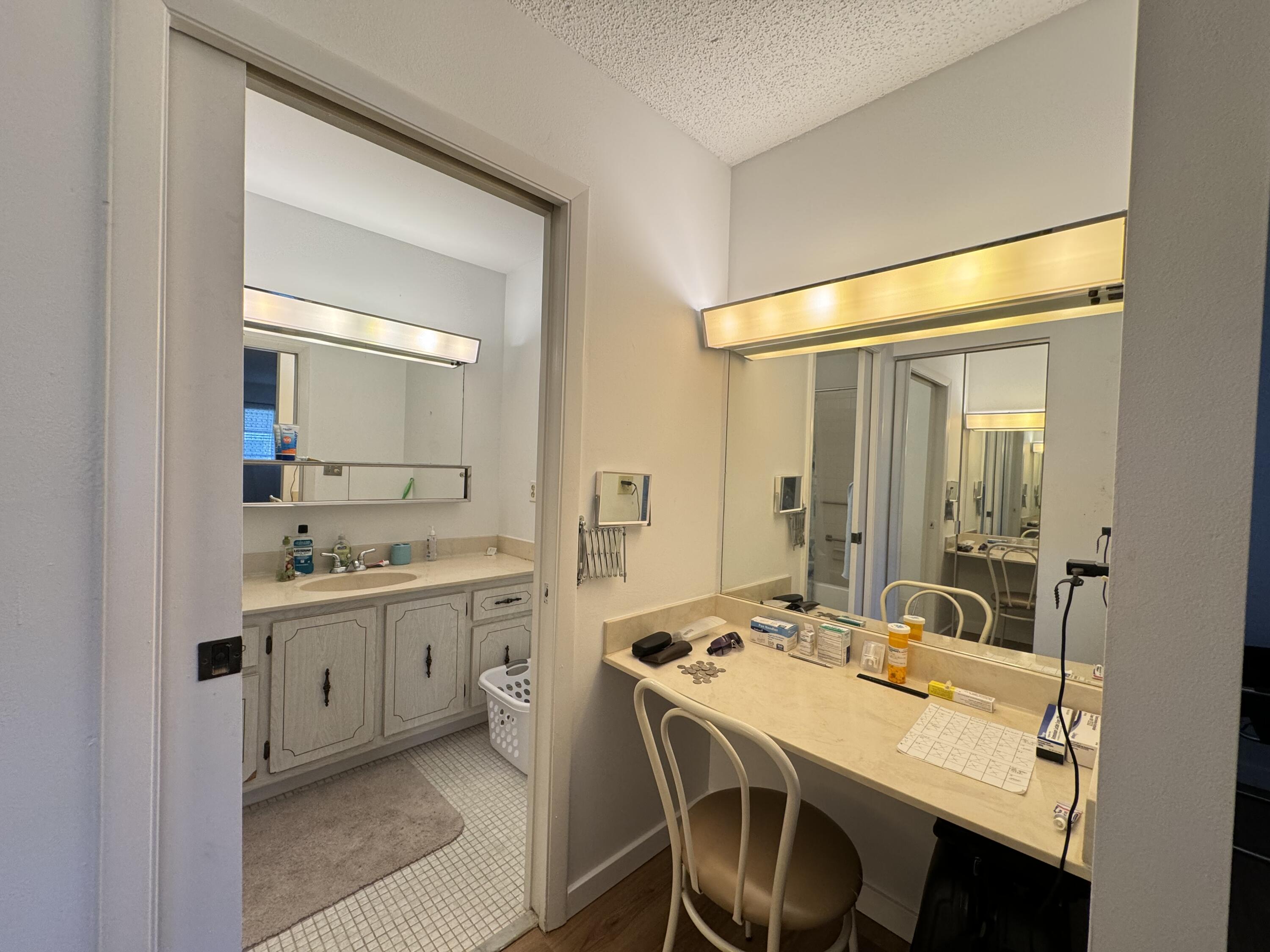4675 Northwest 3rd Court, Unit B Delray Beach, FL 33445 - Photo 11 of 28 a bathroom with a sink vanity granite tub and a mirror