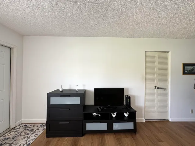 a view of hallway with wooden floor