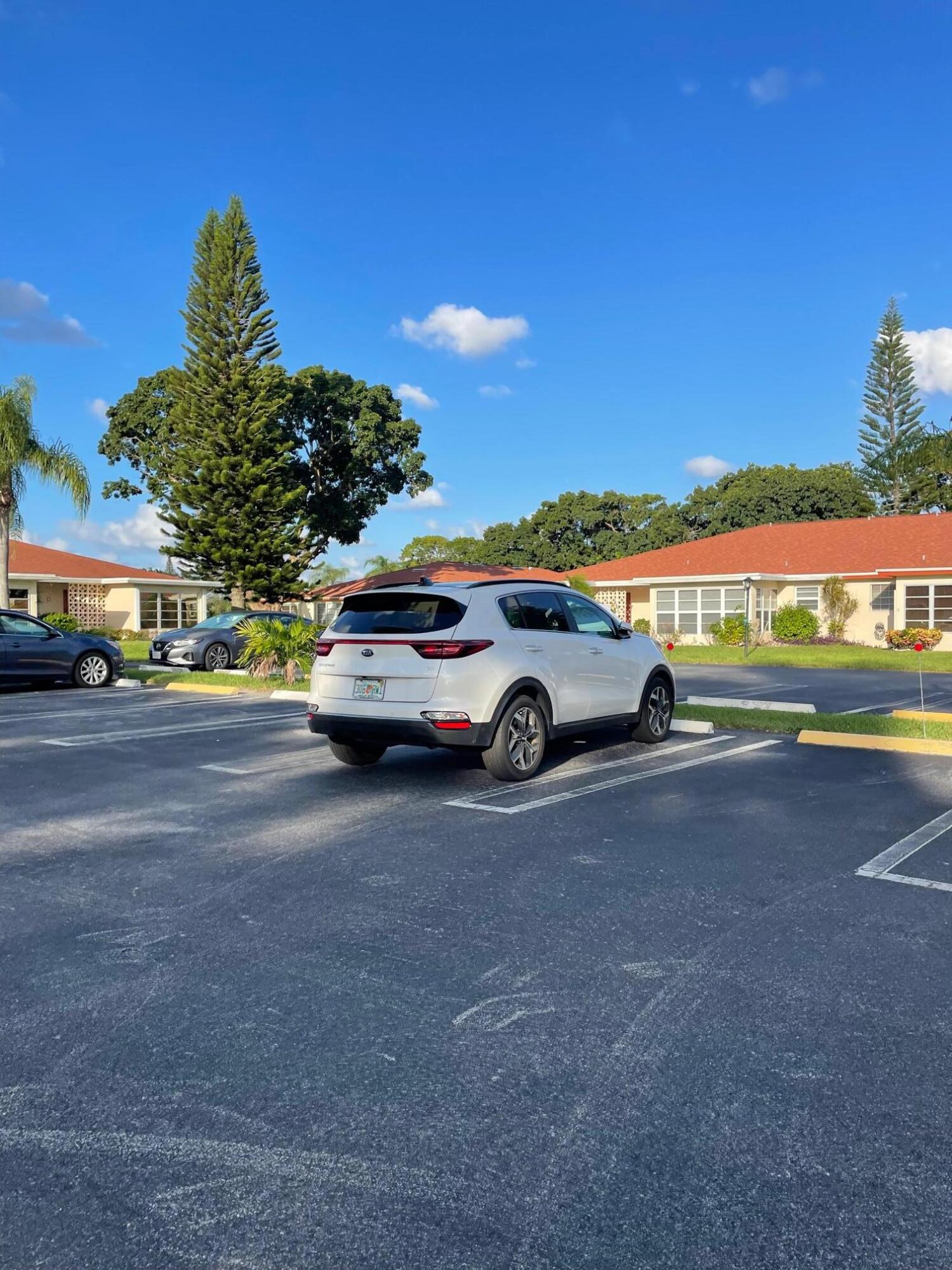 4675 Northwest 3rd Court, Unit B Delray Beach, FL 33445 - Photo 22 of 28 a car parked on the side of the road