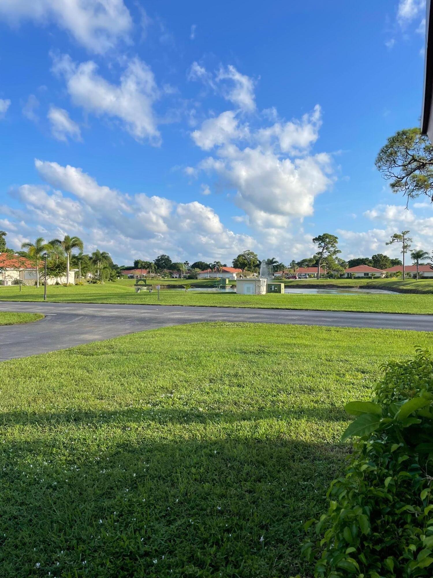 4675 Northwest 3rd Court, Unit B Delray Beach, FL 33445 - Photo 23 of 28 a view of a golf course with a lake