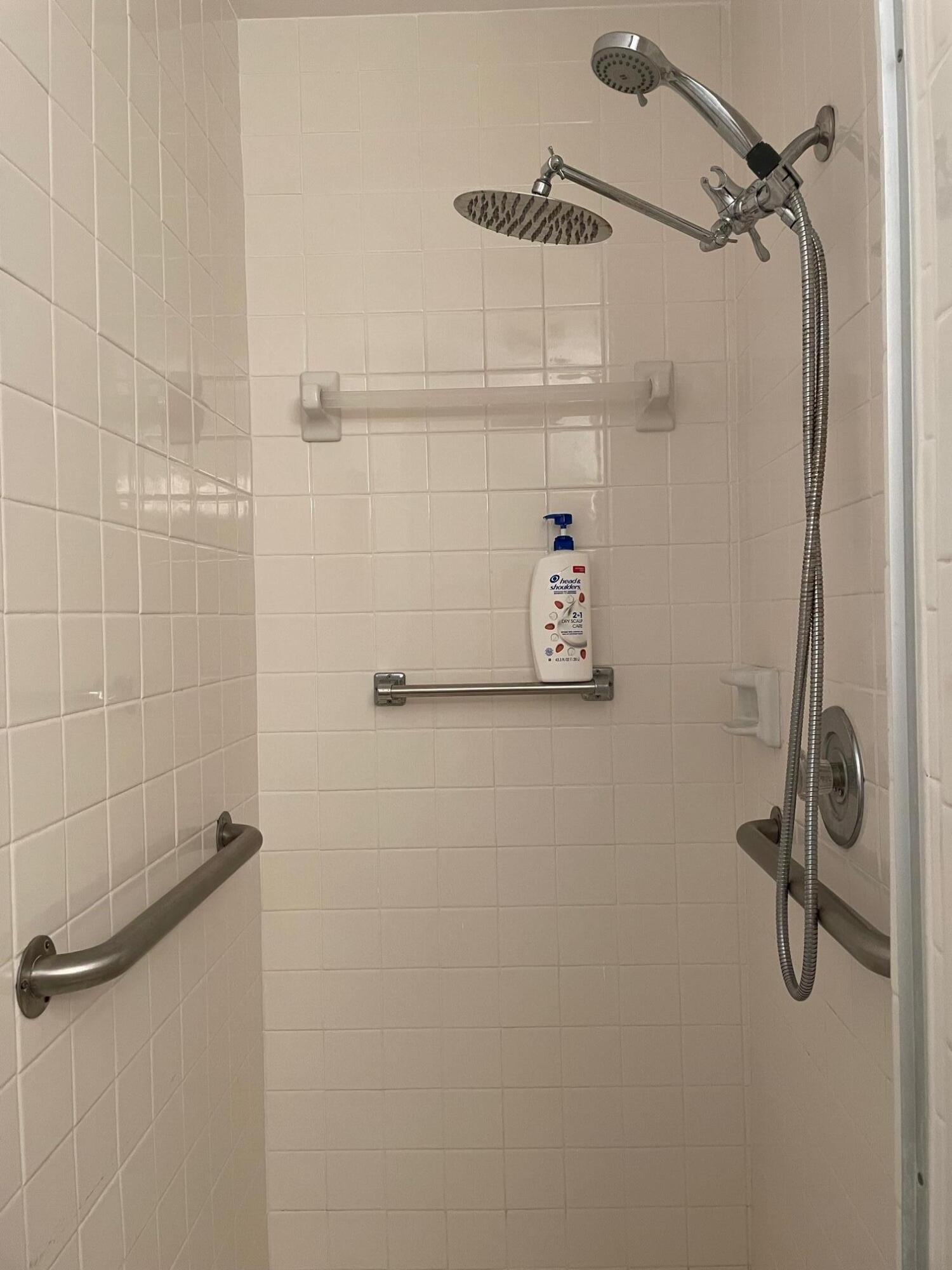 4675 Northwest 3rd Court, Unit B Delray Beach, FL 33445 - Photo 26 of 28 a bathroom with a shower