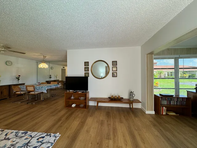 a living room with furniture and large windows