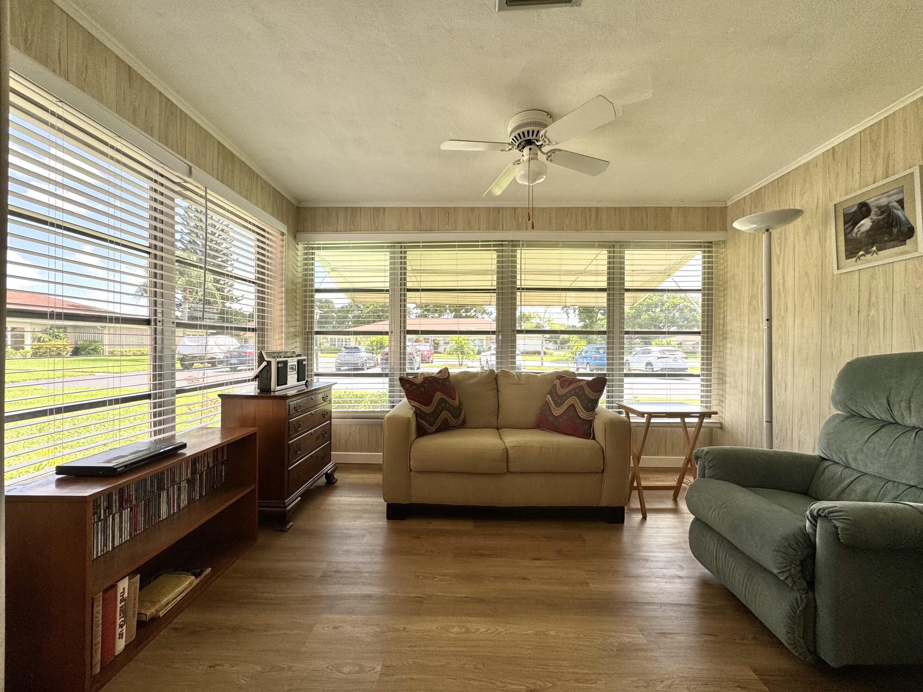 4675 Northwest 3rd Court, Unit B Delray Beach, FL 33445 - Photo 7 of 28 a living room with furniture and large windows