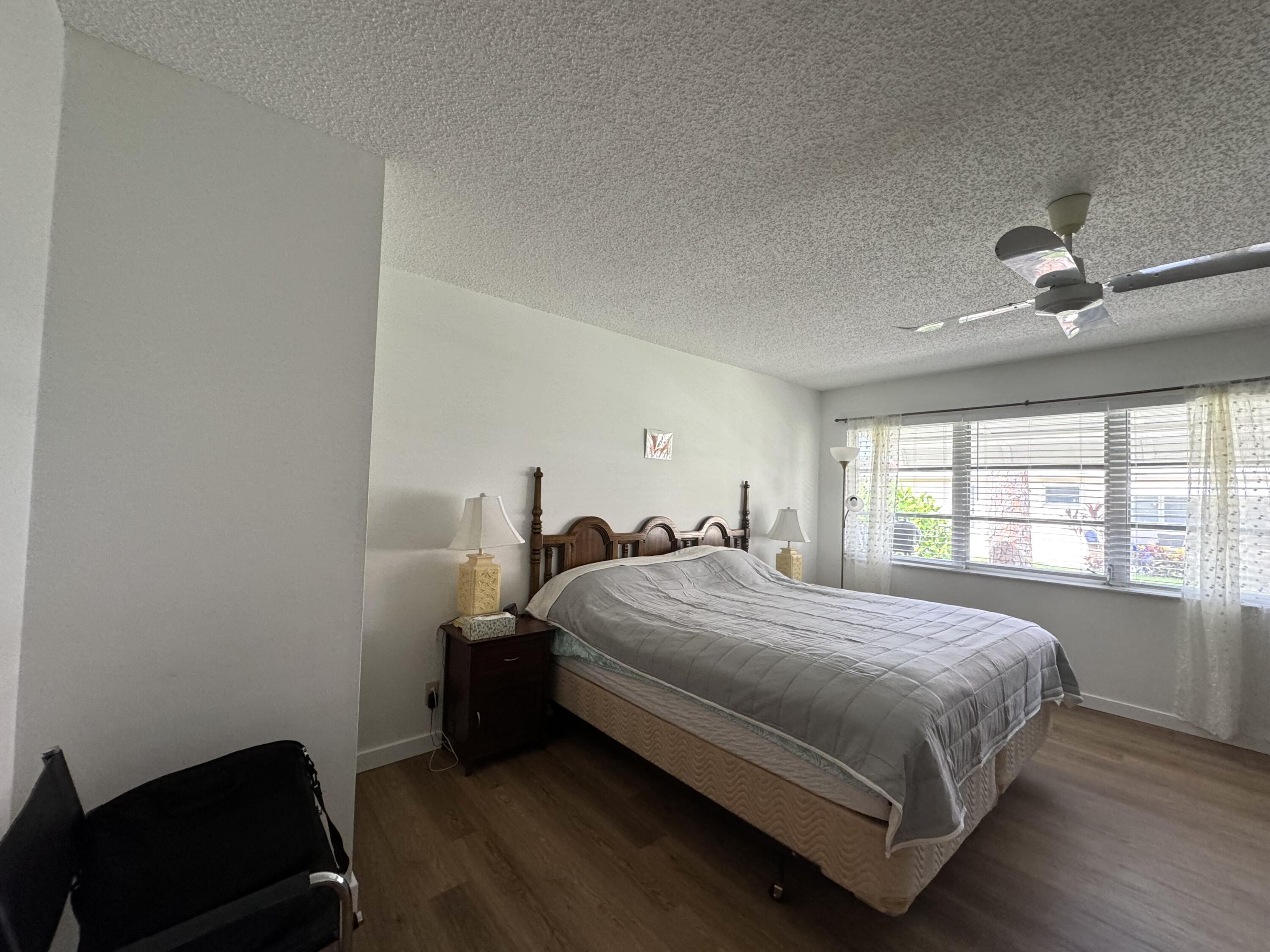 4675 Northwest 3rd Court, Unit B Delray Beach, FL 33445 - Photo 9 of 28 a bedroom with a bed and a window