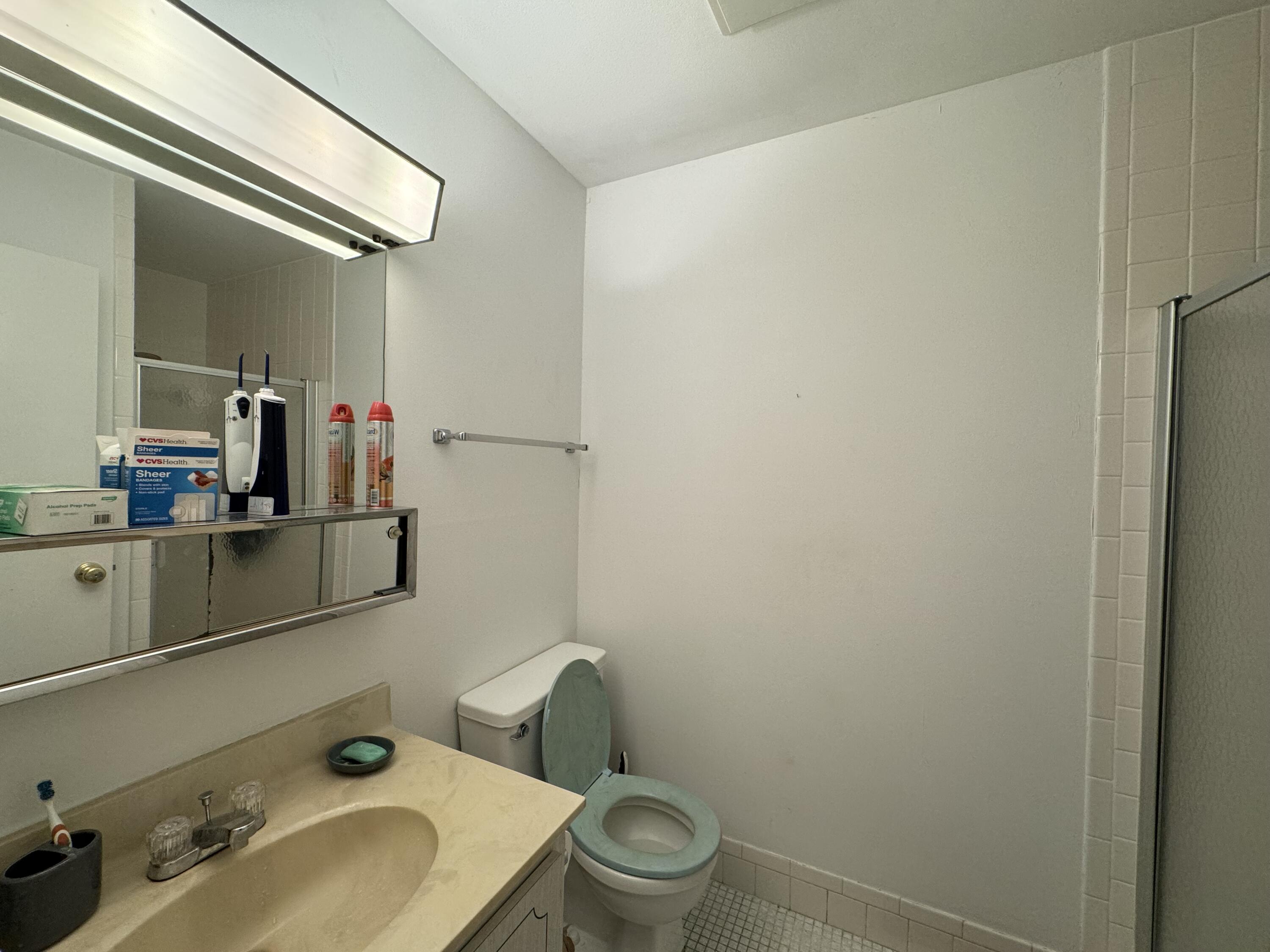 4675 Northwest 3rd Court, Unit B Delray Beach, FL 33445 - Photo 10 of 28 a bathroom with a sink and a toilet