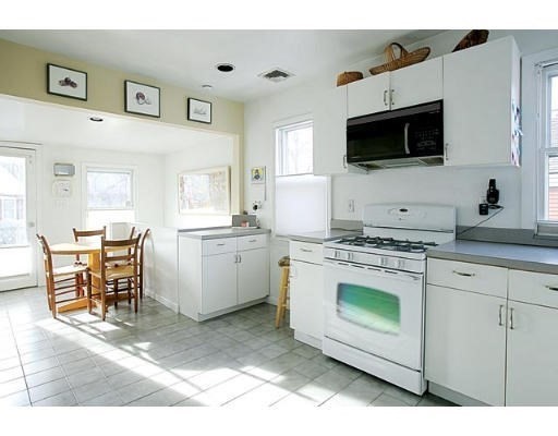 1003 Chestnut Street, Unit 1003 Newton, MA 02464 - Photo 1 of 28 a kitchen with stainless steel appliances a stove microwave and white cabinets