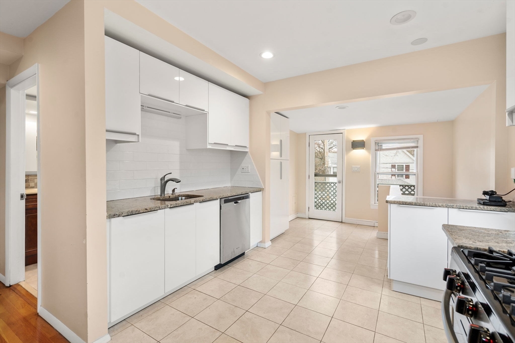 1003 Chestnut Street, Unit 1003 Newton, MA 02464 - Photo 18 of 28 a kitchen with stainless steel appliances granite countertop a sink and cabinets