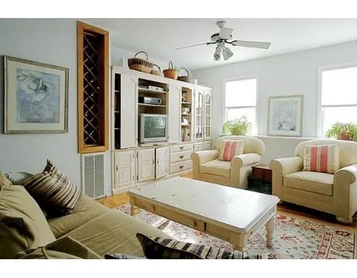 a living room with furniture a chandelier and a large window