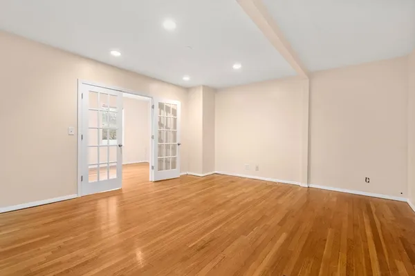 a view of an empty room with wooden floor