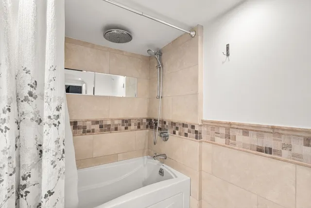 a bathroom with a bathtub and a shower
