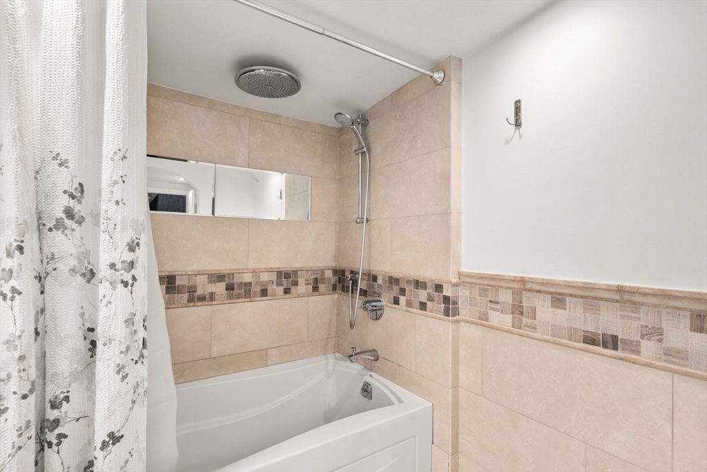 1003 Chestnut Street, Unit 1003 Newton, MA 02464 - Photo 8 of 28 a bathroom with a bathtub and a shower