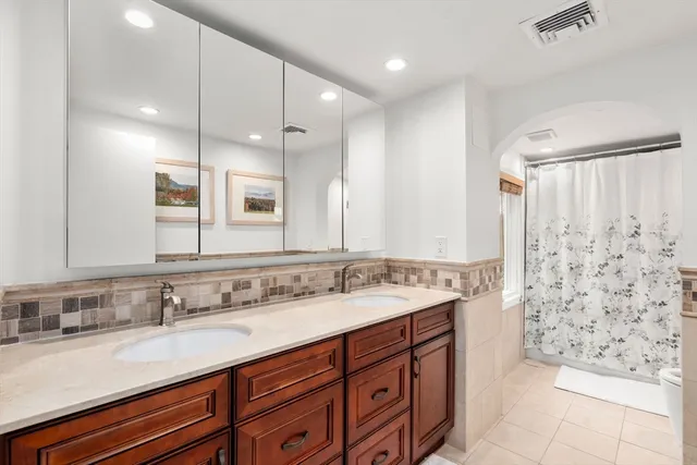 a bathroom with a sink double vanity and a mirror