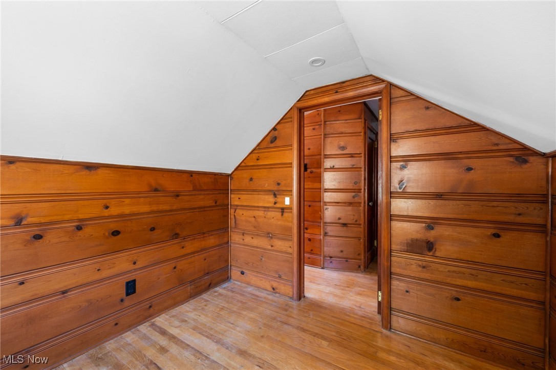 18122 Nottingham Road Cleveland, OH 44119 - Photo 21 of 29 Bedroom featuring lofted ceiling, light wood finished floors, and wooden walls