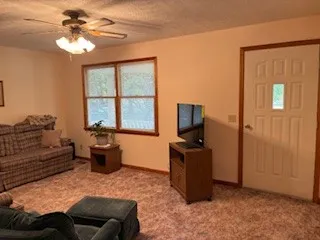 a living room with furniture a couch and a chandelier