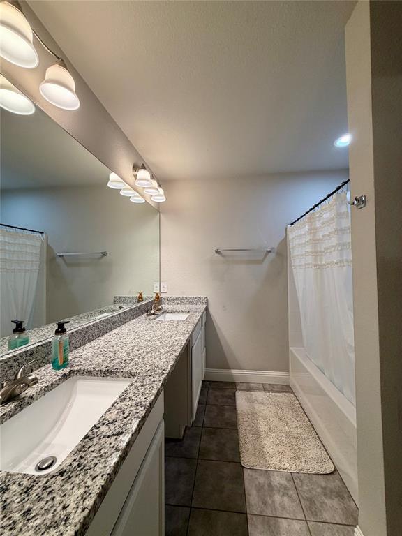 619 Mansfield Road Cleburne, TX 76031 - Photo 10 of 19 Dual vanity with speckled countertop and integrated sinks