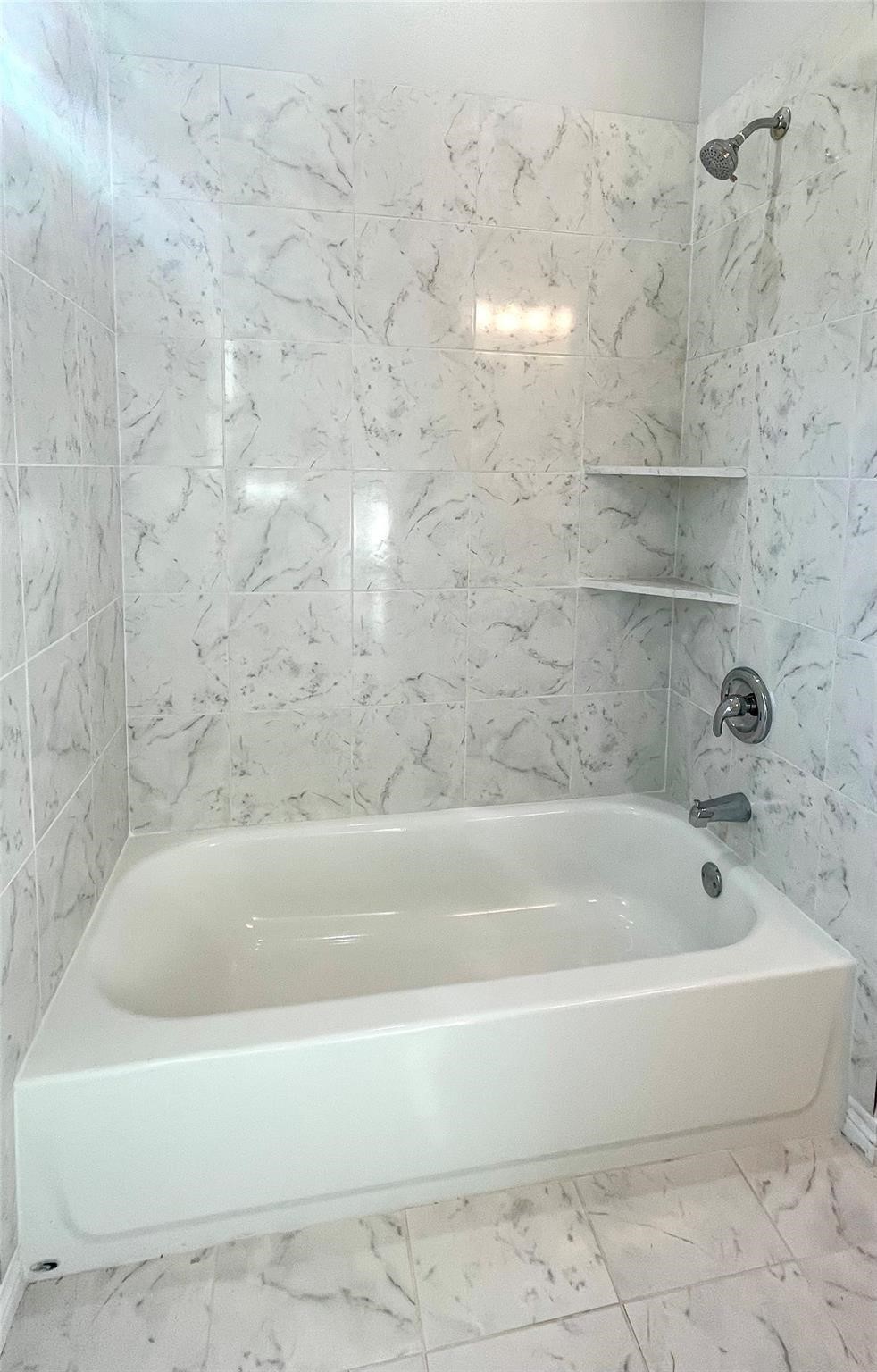 2352 Cedar Place Drive Conroe, TX 77306 - Photo 12 of 26 a white bath tub sitting next to a white sink and vanity