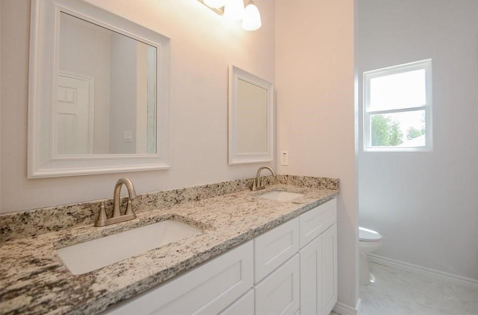 2352 Cedar Place Drive Conroe, TX 77306 - Photo 15 of 26 a bathroom with a granite countertop sink and a mirror