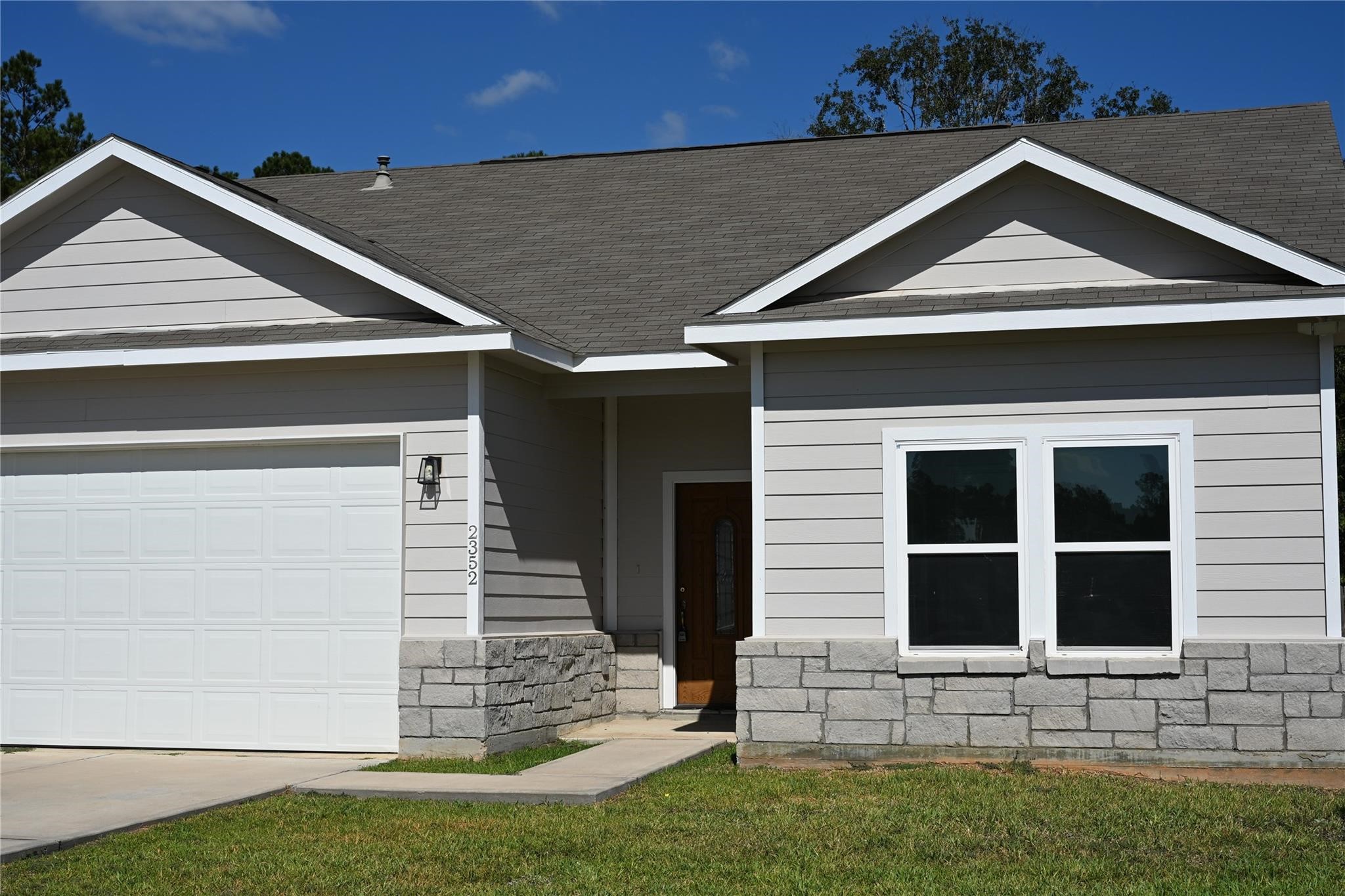 2352 Cedar Place Drive Conroe, TX 77306 - Photo 2 of 26 a front view of a house with a yard