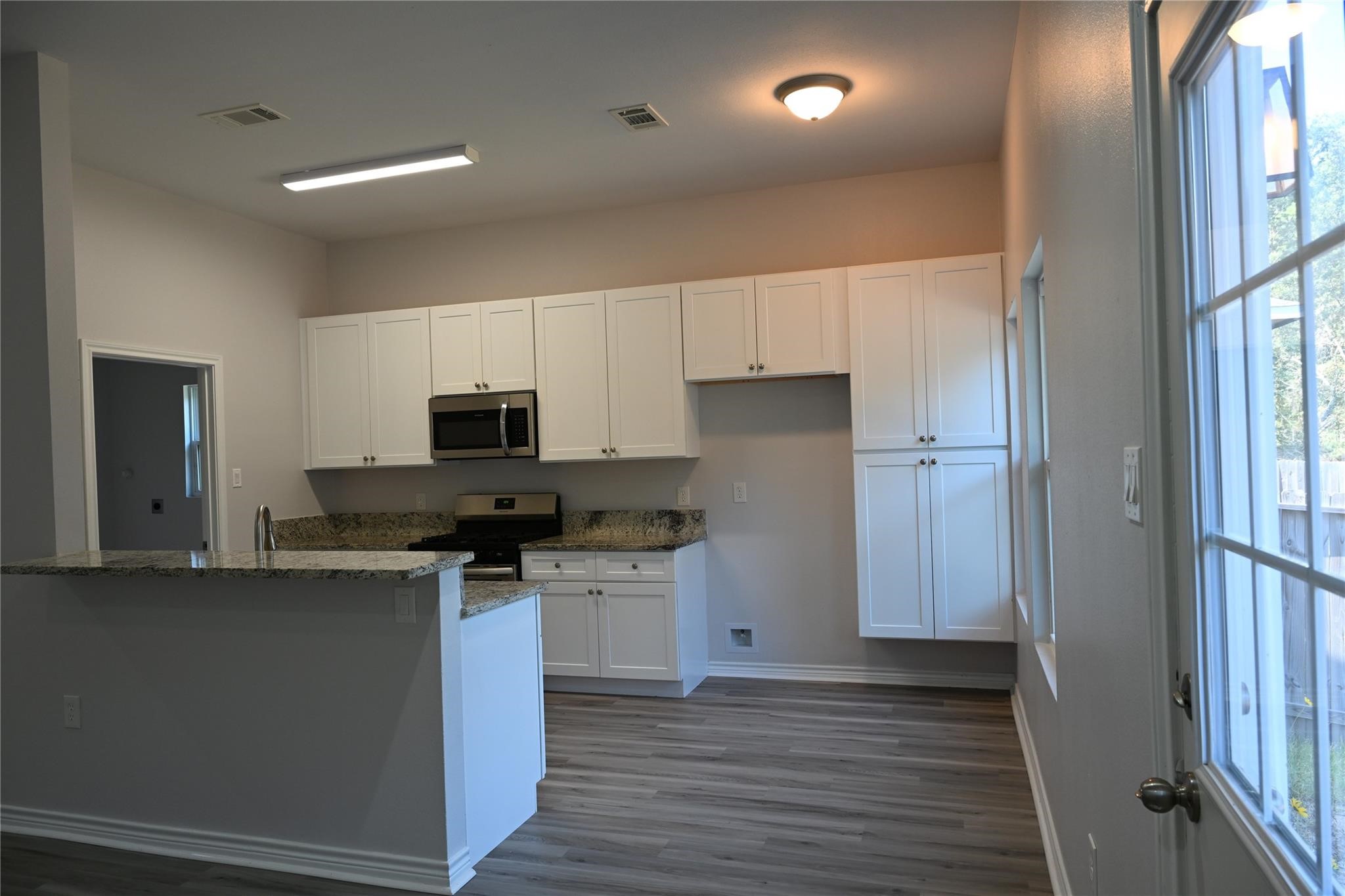 2352 Cedar Place Drive Conroe, TX 77306 - Photo 9 of 26 a kitchen with stainless steel appliances a refrigerator and a stove top oven