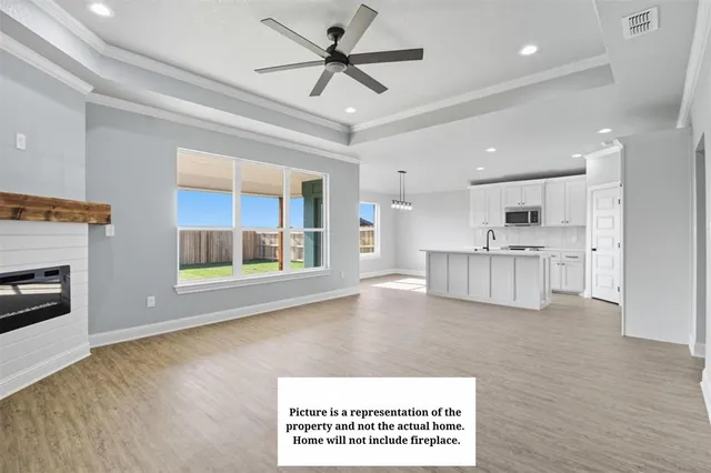 a view of an empty room with a fireplace and a window