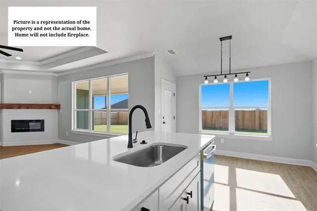 a kitchen with a sink a stove and a microwave