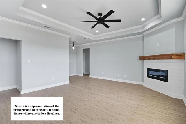 a view of a livingroom with a ceiling fan a fireplace and a ceiling fan