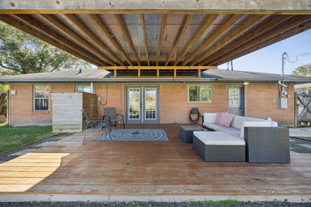 1122 West 31st Street Houston, TX 77018 - Photo 11 of 12 a patio with couches and a dining table and chairs with wooden floor