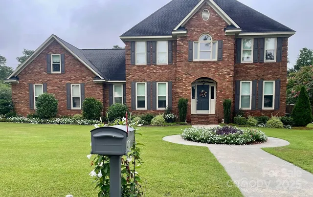 a front view of a house with garden and patio