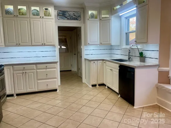 a kitchen with a sink cabinets and wooden floor