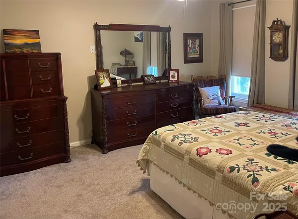 a bedroom with a bed and a mirror