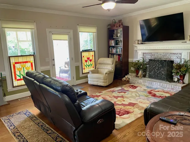 a living room with fireplace furniture and a flat screen tv