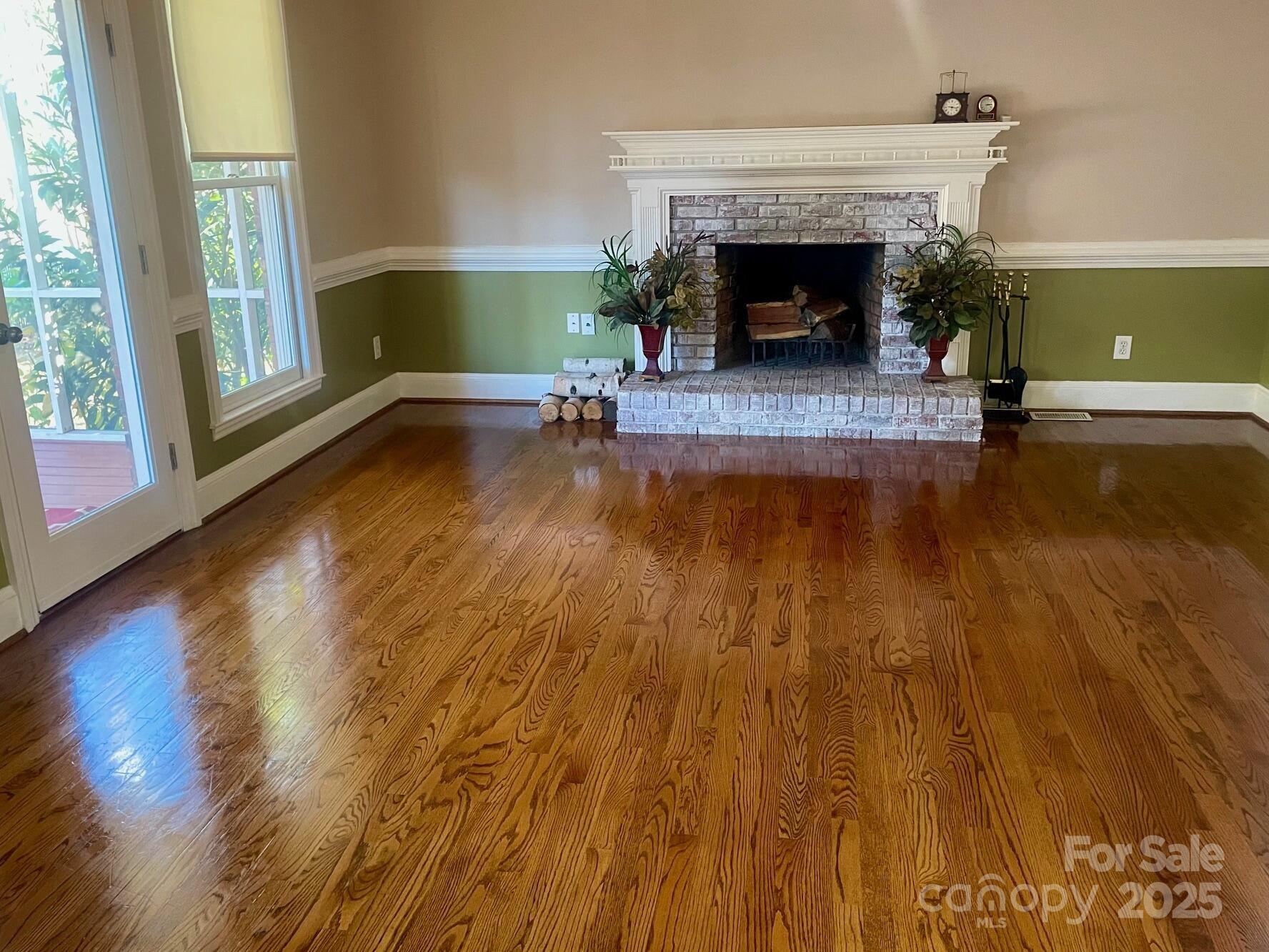 417 Oxford Road Lexington, SC 29072 - Photo 10 of 27 a living room with hard wood floors and a fireplace