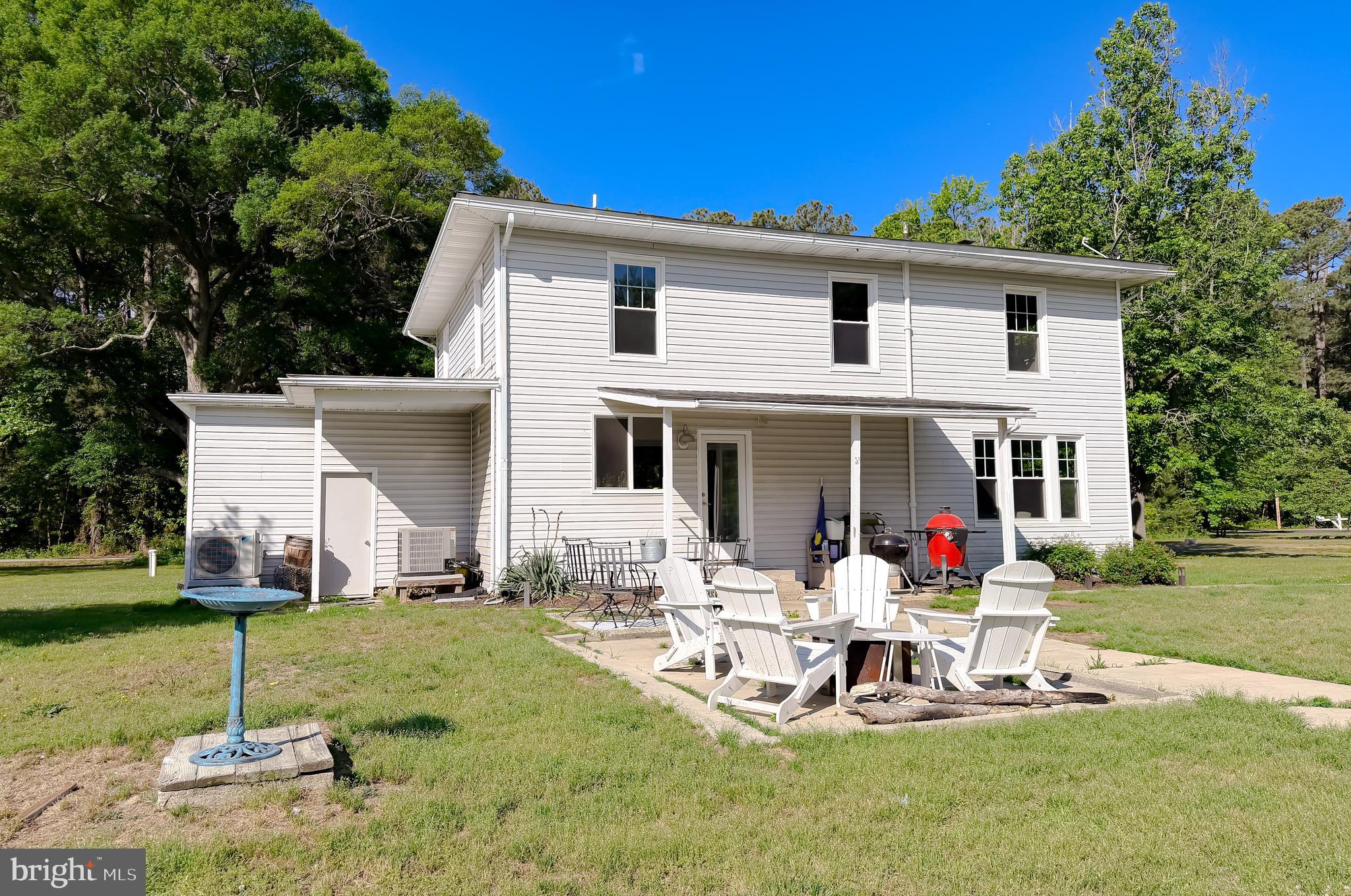 16146 Thomas Road Piney Point, MD 20674 - Photo 54 of 57 a front view of a house with garden and chairs