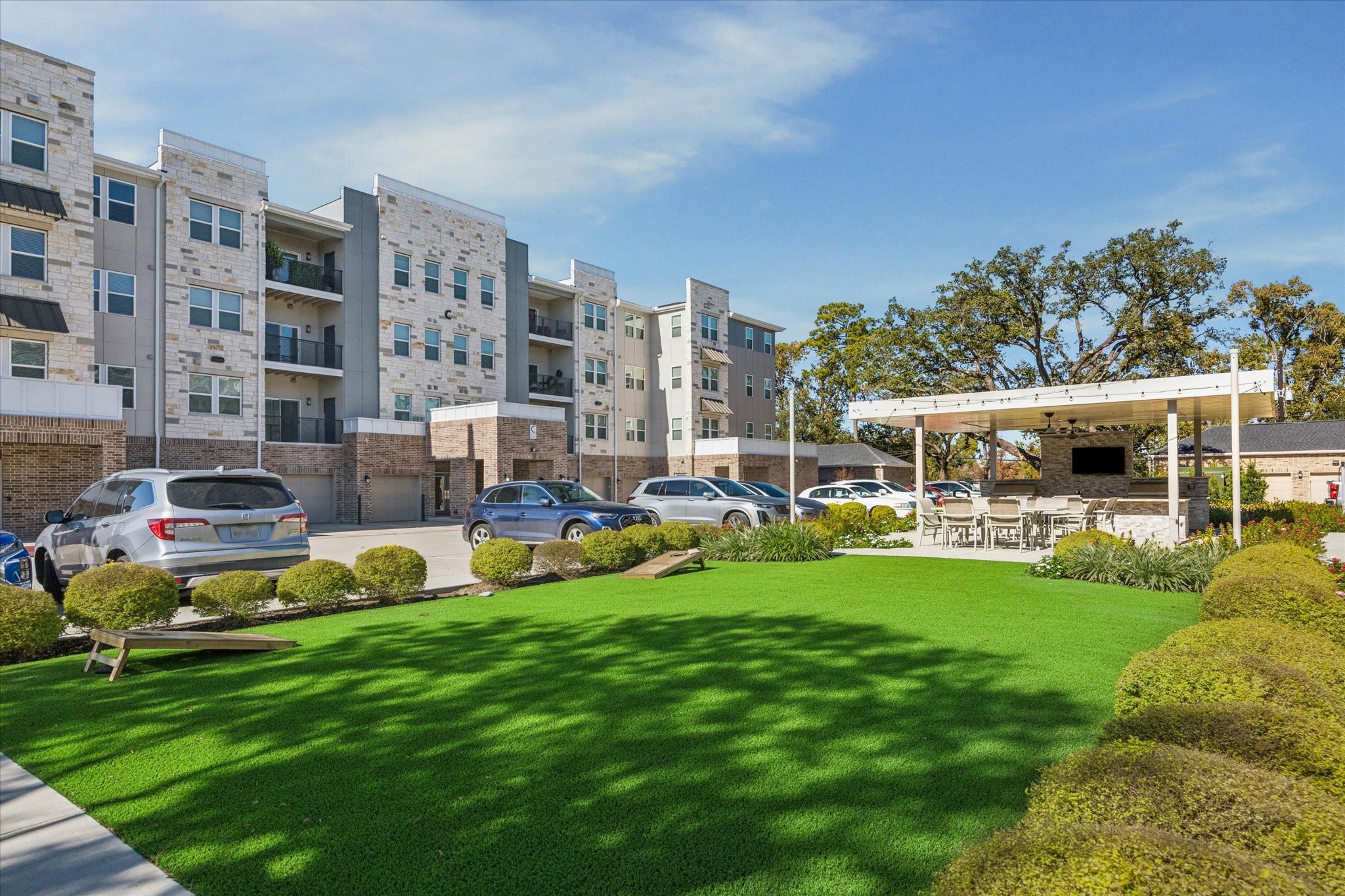 6804 Westview Drive, Unit 2205 Houston, TX 77055 - Photo 17 of 23 This community offers an expansive outdoor social green space, featuring professionally manicured turf perfect for lawn games and leisure.