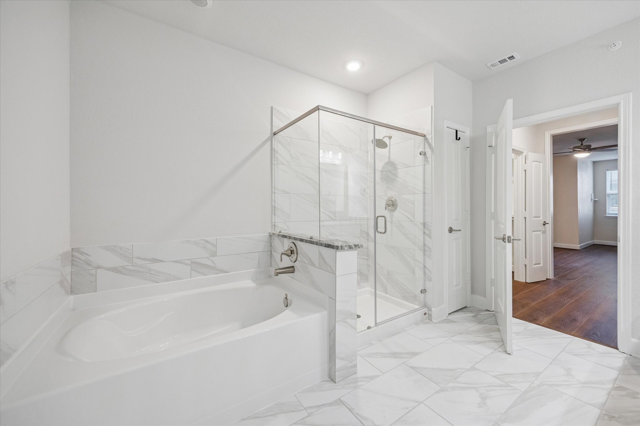 6804 Westview Drive, Unit 2205 Houston, TX 77055 - Photo 8 of 23 Primary Bath- Enjoy the separate glass-enclosed shower alongside a deep soaking tub.