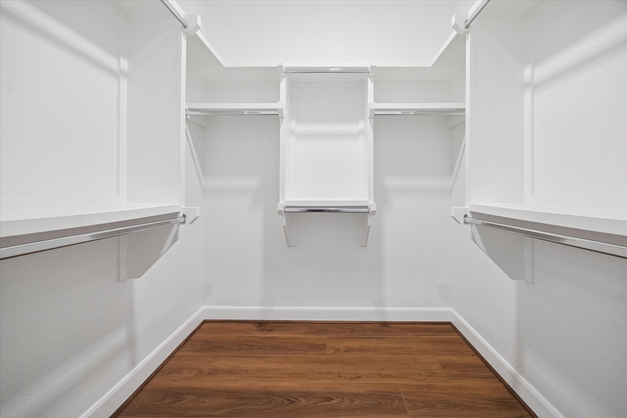 6804 Westview Drive, Unit 2205 Houston, TX 77055 - Photo 9 of 23 This expansive primary walk-in closet offers exceptional organization with floor-to-ceiling built-in shelving and ample hanging space. A second walk-in closet is located directly across (not shown).