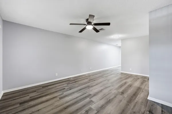 a view of a room with wooden floor