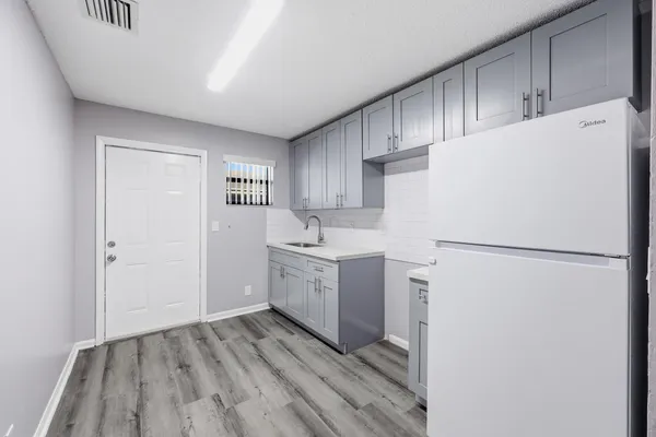 a white refrigerator freezer sitting inside of a kitchen