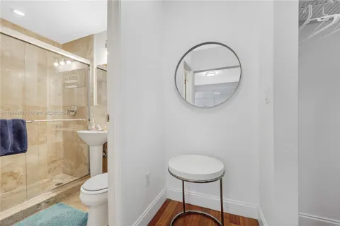 a bathroom with a toilet a sink and a mirror