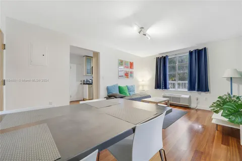 a living room with kitchen island furniture and a chandelier