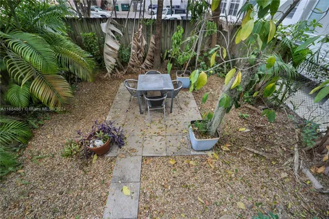 a view of a backyard with plants and lounge chair