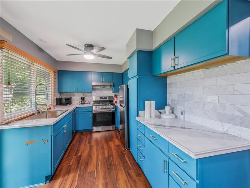 1968 Holbrook Lane Hoffman Estates, IL 60169 - Photo 15 of 31 a kitchen with stainless steel appliances kitchen island granite countertop a sink stove and cabinets