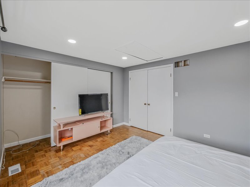 1968 Holbrook Lane Hoffman Estates, IL 60169 - Photo 26 of 31 a bedroom with a bed and a flat screen tv