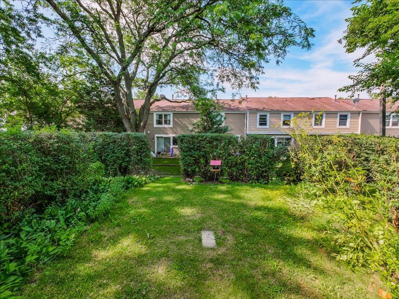 1968 Holbrook Lane Hoffman Estates, IL 60169 - Photo 27 of 31 a front view of a house with a garden