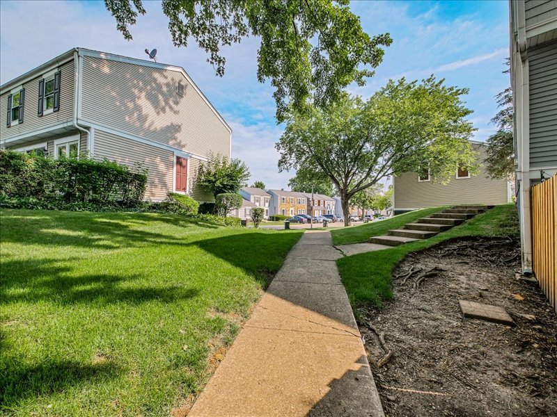 1968 Holbrook Lane Hoffman Estates, IL 60169 - Photo 30 of 31 a front view of a building with a garden