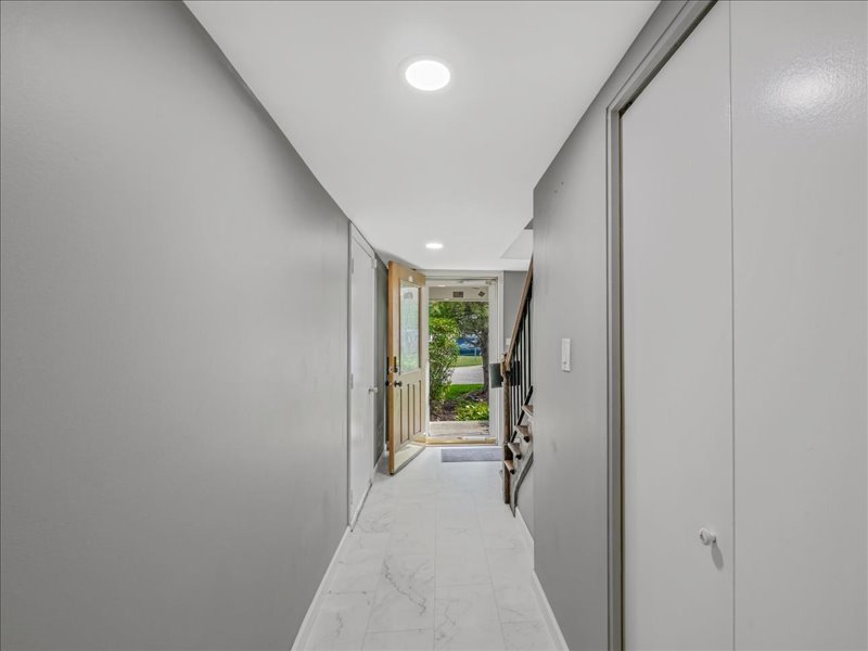 1968 Holbrook Lane Hoffman Estates, IL 60169 - Photo 6 of 31 a view of a hallway with wooden floor and a bathroom