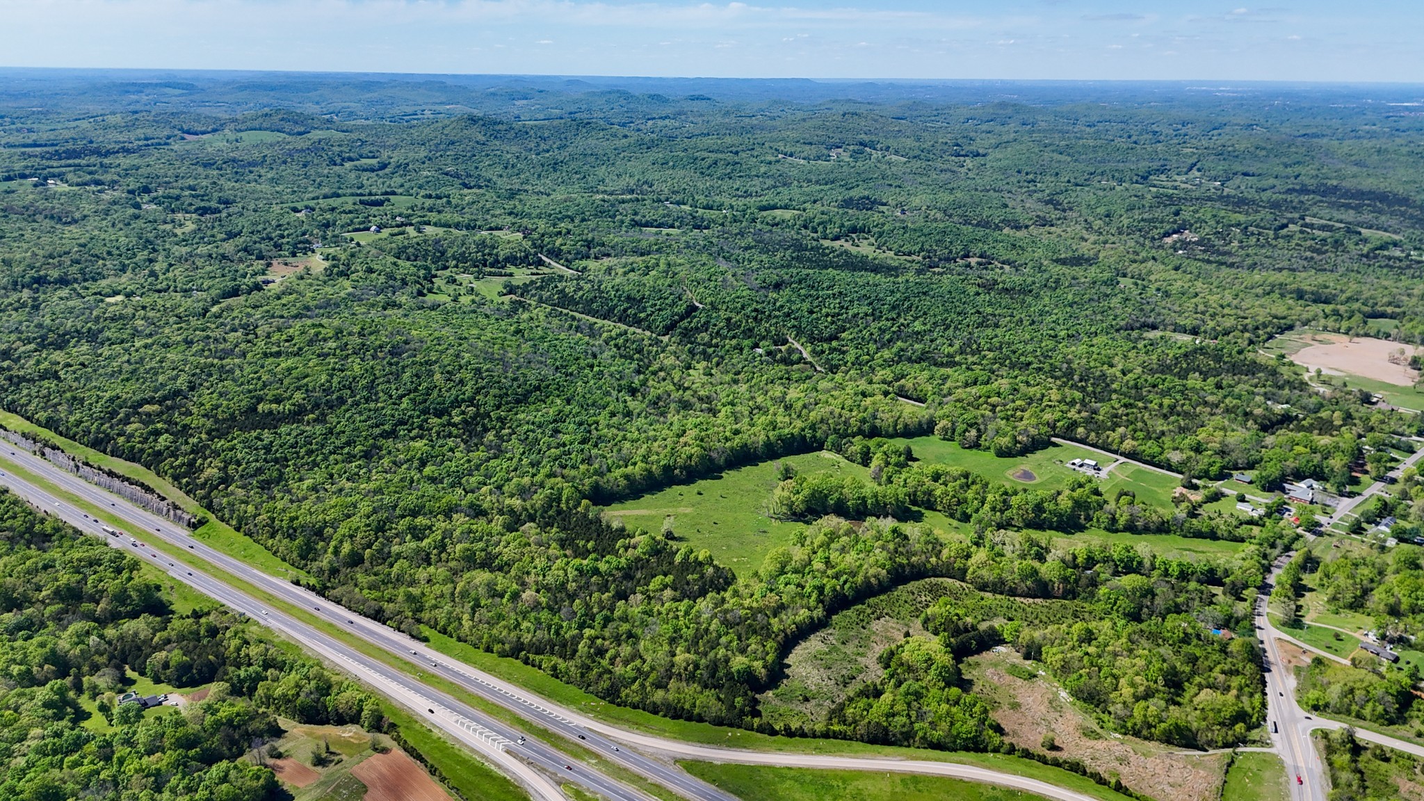 9147 Spantown Road Arrington, TN 37014 - Photo 10 of 15 a view of a green field with lots of bushes
