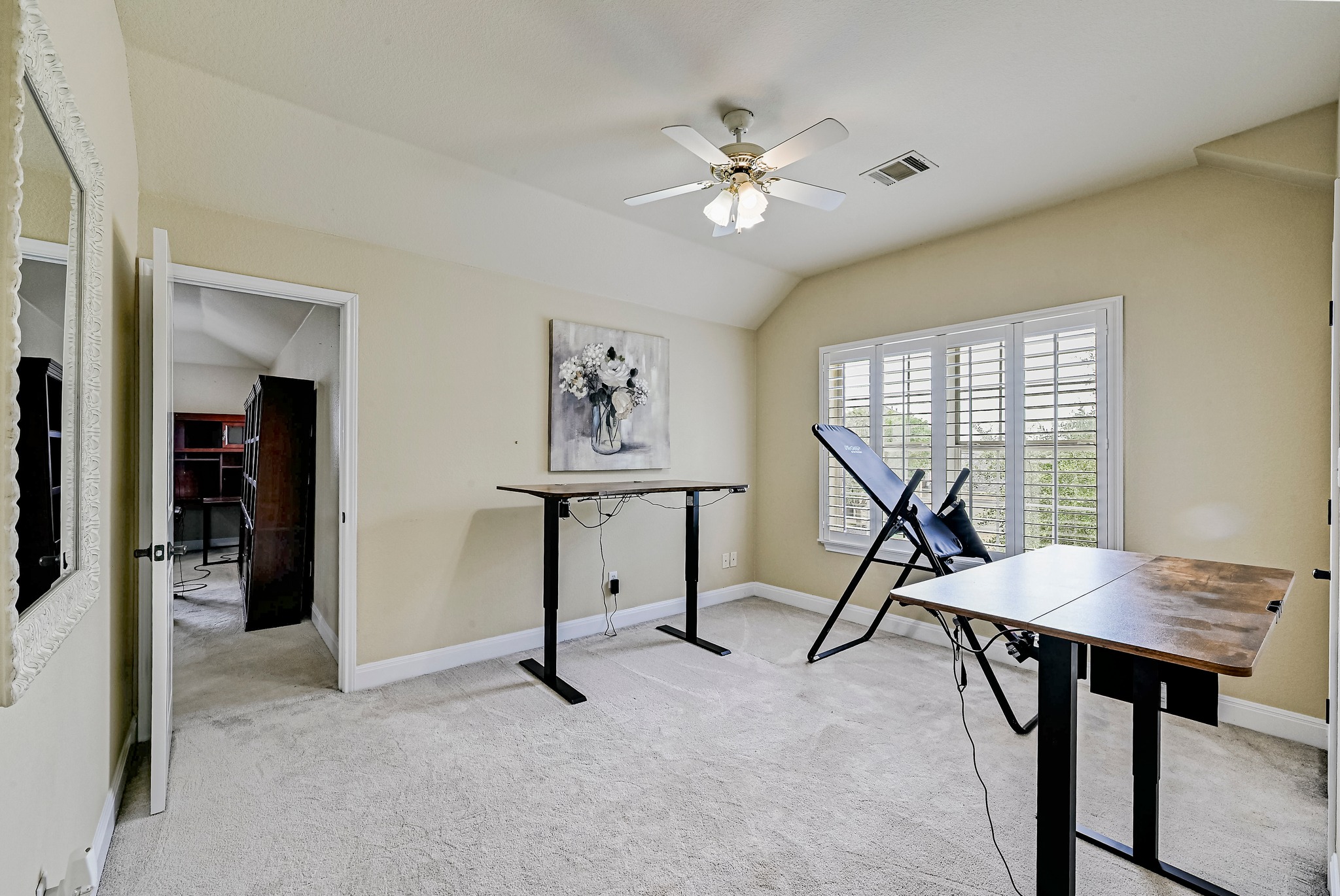 2408 Amen Corner Road Pflugerville, TX 78660 - Photo 26 of 40 Carpeted room featuring a ceiling fan, a window with white plantation shutters, and a sloped ceiling detail