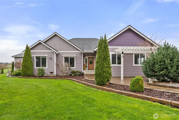 a front view of a house with a yard and porch