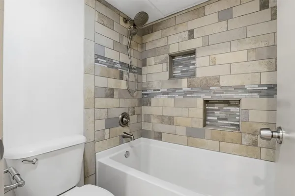 a bathroom with bathtub and shower